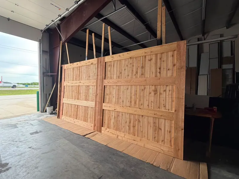 Custom wood driveway gate panels built by Tovar Garage Doors in Fort Worth