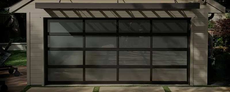 Modern full view aluminum and glass garage door on a stucco home