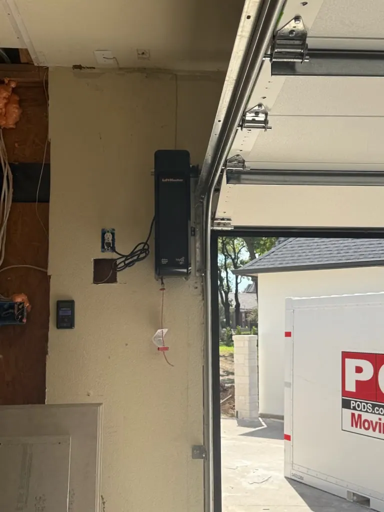 New garage door opener installed on the ceiling of a garage