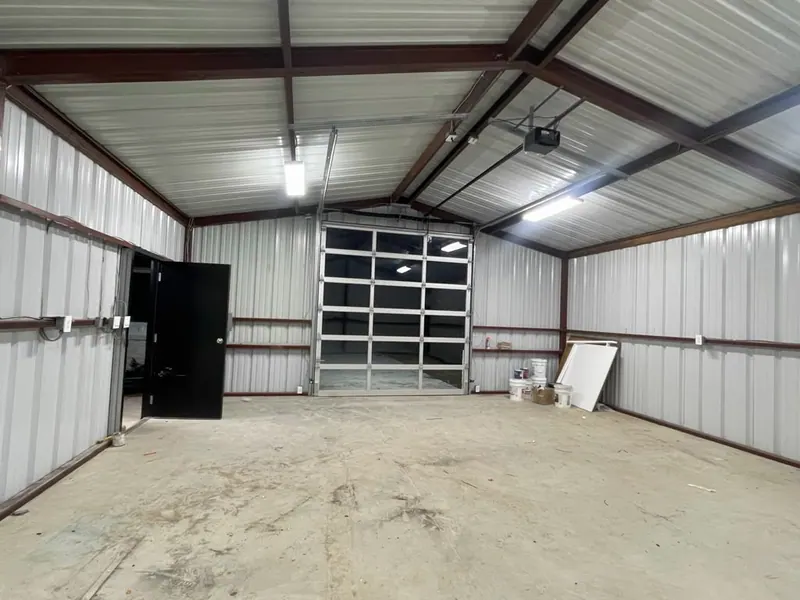 Interior of a metal building with a full view glass overhead door