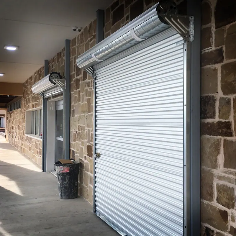 Galvanized roll up door installed on a stone commercial building