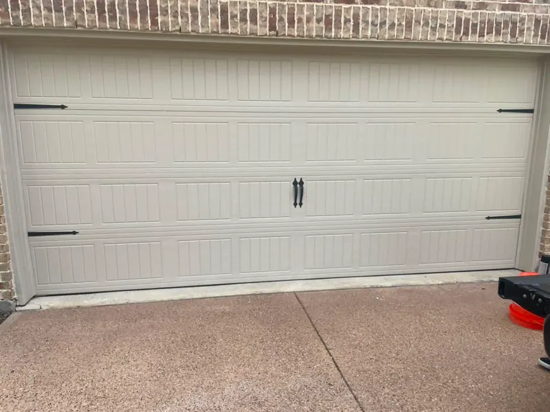 White raised panel two car garage door on a clean driveway